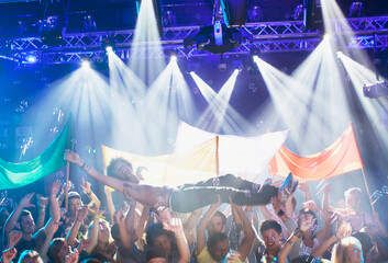 Man crowd surfing at concert