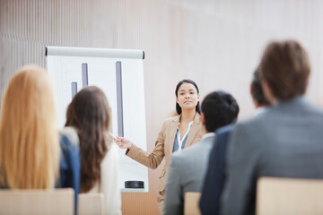 Businesswoman at flipchart leading meeting