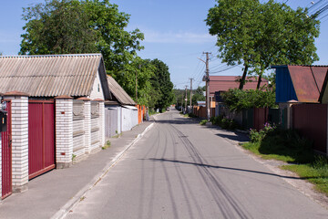 Fototapeta na wymiar street in the village in summer with a blue sky
