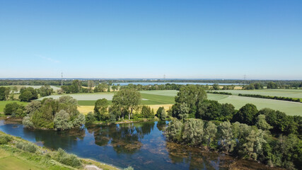 Obraz premium View from the air over agricultural land towards the Alps