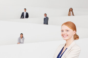 Portrait of smiling businesswoman with coworkers on staircase 