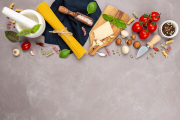 Raw ingredients for italian pasta and vegan sauce:spaghetti,parmesan cheese,fresh basil,mushrooms,dried oregano,tomatoes,garlic,pink sea salt and dried pepper.Top view,copy space for your text.
