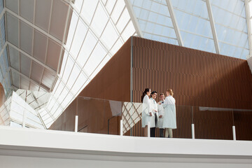 Doctors talking on modern balcony
