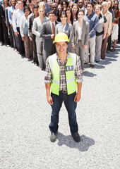 Portrait of smiling construction worker with business people  - obrazy, fototapety, plakaty