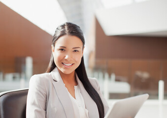Portrait of smiling businesswoman using digital tablet in office