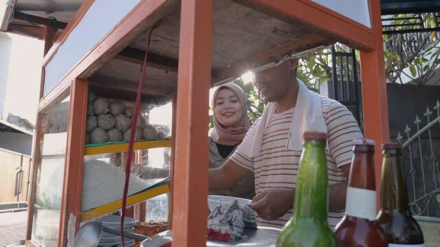 man selling bakso in the carts. indonesia street food vendor. small business entrepreneur