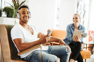 Man and woman relaxing with electronic devices
