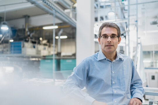 Portrait of a confident mature businessman in a factory
