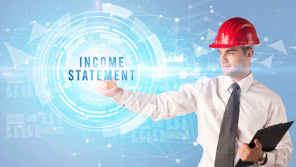 Handsome businessman with helmet drawing INCOME STATEMENT inscription, contruction business concept