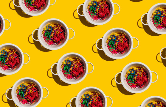 Pattern of colanders with colorful pasta