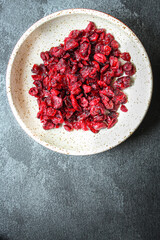 dried cranberries dried berries cherry sweet and healthy treat Menu concept serving size. food background top view copy space for text organic healthy eating