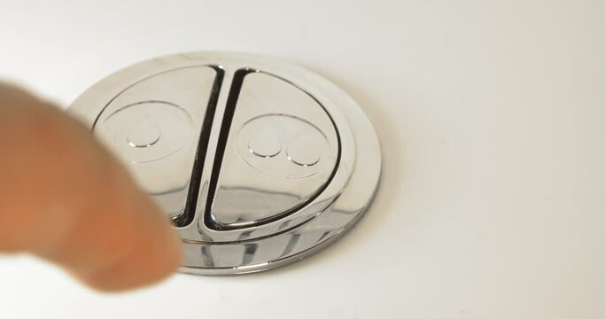 A person flushing the toilet with a home Energy Savings High Efficiency Toilets, Low Flow Toilet. Top Low Flush, Water Saving, Energy Efficient.