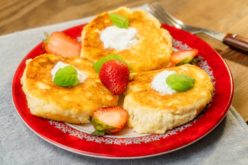 cheesecakes with raspberry and sour cream on a plate