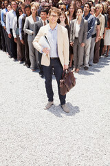 Obraz premium Portrait of confident businessman with business people in background