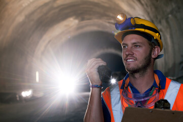 Worker using walkie-talkie in tunnel