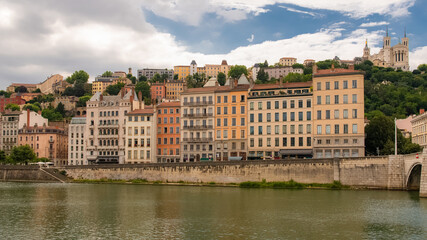 Fototapeta premium Vieux-Lyon, colorful houses in the center, on the river Saone, with the Fourviere cathedral in background 