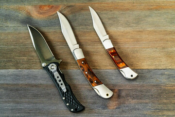 set of hunting knives on wooden background