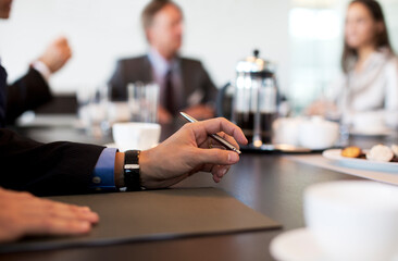 Close up of businessman's hand in meeting