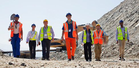 Workers and business people walking in quarry - obrazy, fototapety, plakaty