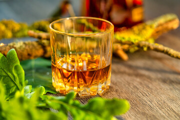 Glass of whiskey on a wooden table