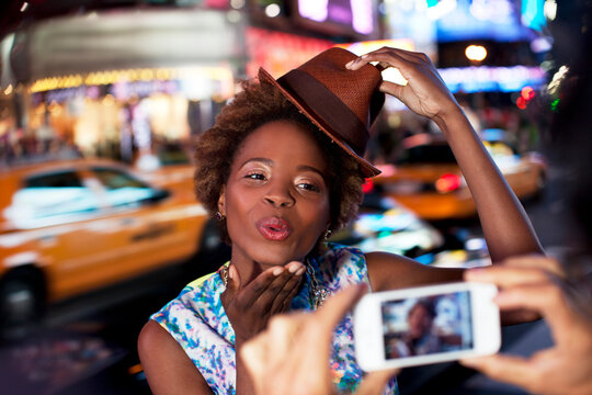 Couple taking pictures on city street