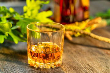 Glass of whiskey on a wooden table