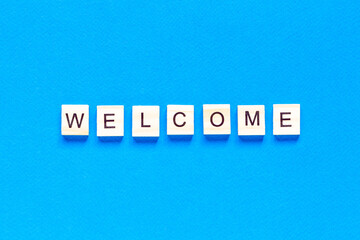 welcome sign in wooden letters on a blue background. Business concept, sales, stores, gifts. top view. The view from the top.