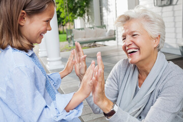 Woman and granddaughter playing clapping game