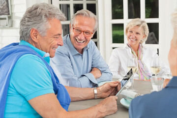 Friends using digital tablet together