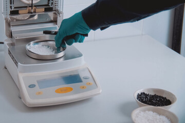 Weighing the components of explosive on electronic scales.