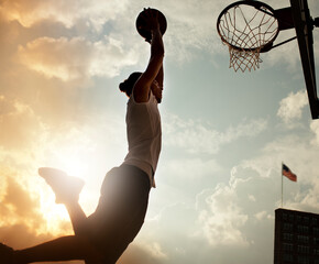 Man dunking basketball on court