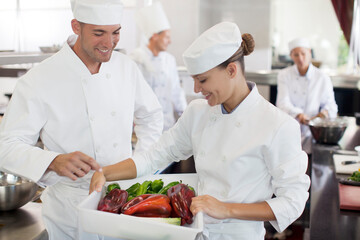 Fototapeta na wymiar Chefs examining vegetables in restaurant kitchen