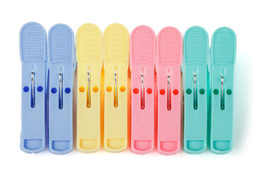 Color plastic clothespins isolated on white background. Plastic clips. Close-up.