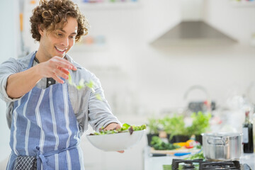 Man making salad in kitchen