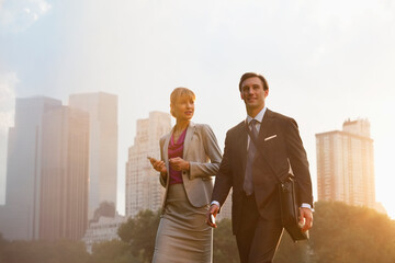 Business people walking in urban park