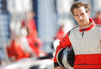 Racer holding helmet on track
