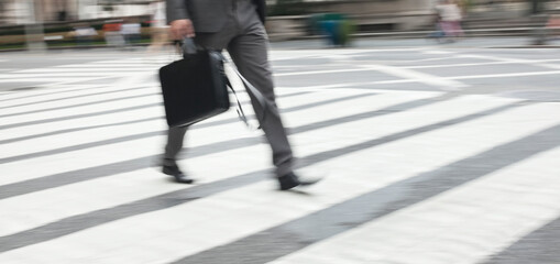 Businessman crossing city street