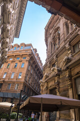 Fototapeta na wymiar Genoa, Italy - August 18, 2019: Via XX Setembre, the main boulevard in Genoa with its arcades, beautiful buildings and a wide variety of modern shops