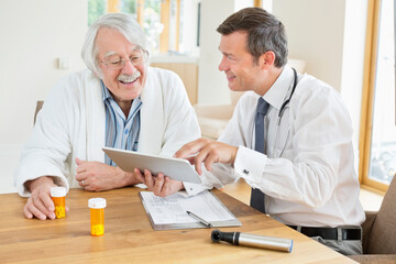 Doctor talking to older patient at house call