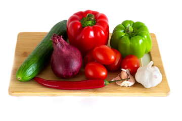 Closeup exposure of fresh organic vegetables on a wooden board.