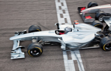 Race car crossing finish line on track