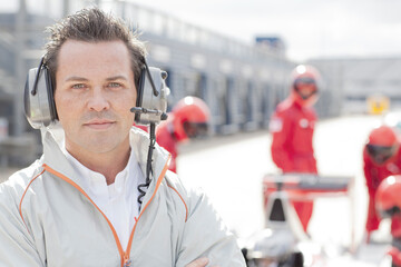 Race manager wearing headphones on track