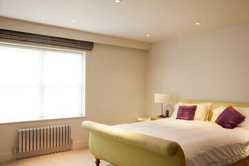 Bed and radiator in modern bedroom