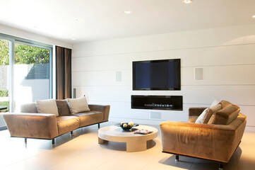 Obraz na płótnie Canvas Sofas and television in modern living room
