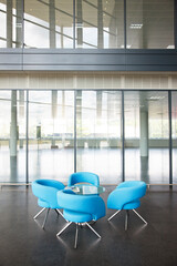 Chairs and table in office lobby area