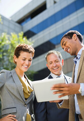 Fototapeta premium Business people using tablet computer outdoors