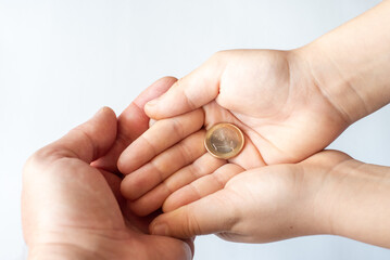 Close up of father and child hands holding euro money coins. Family, children, money, Investments, people concept