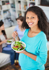 Pregnant woman eating salad