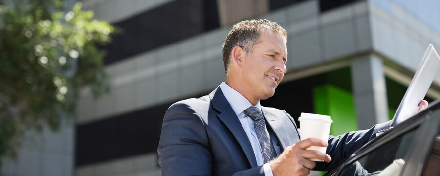 Businessman using tablet computer outdoors