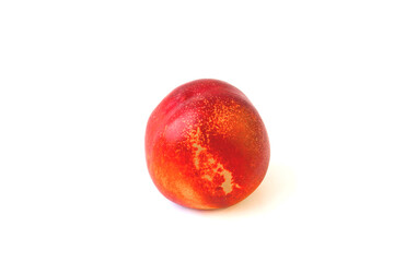 One little peach on a white background. Ripe peach, red with yellow spots, fruite and good health food for snack